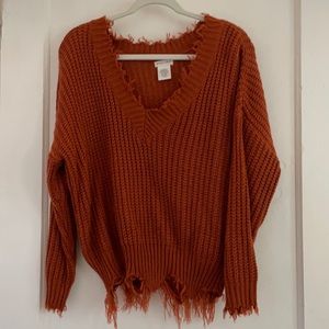 Distressed orange sweater